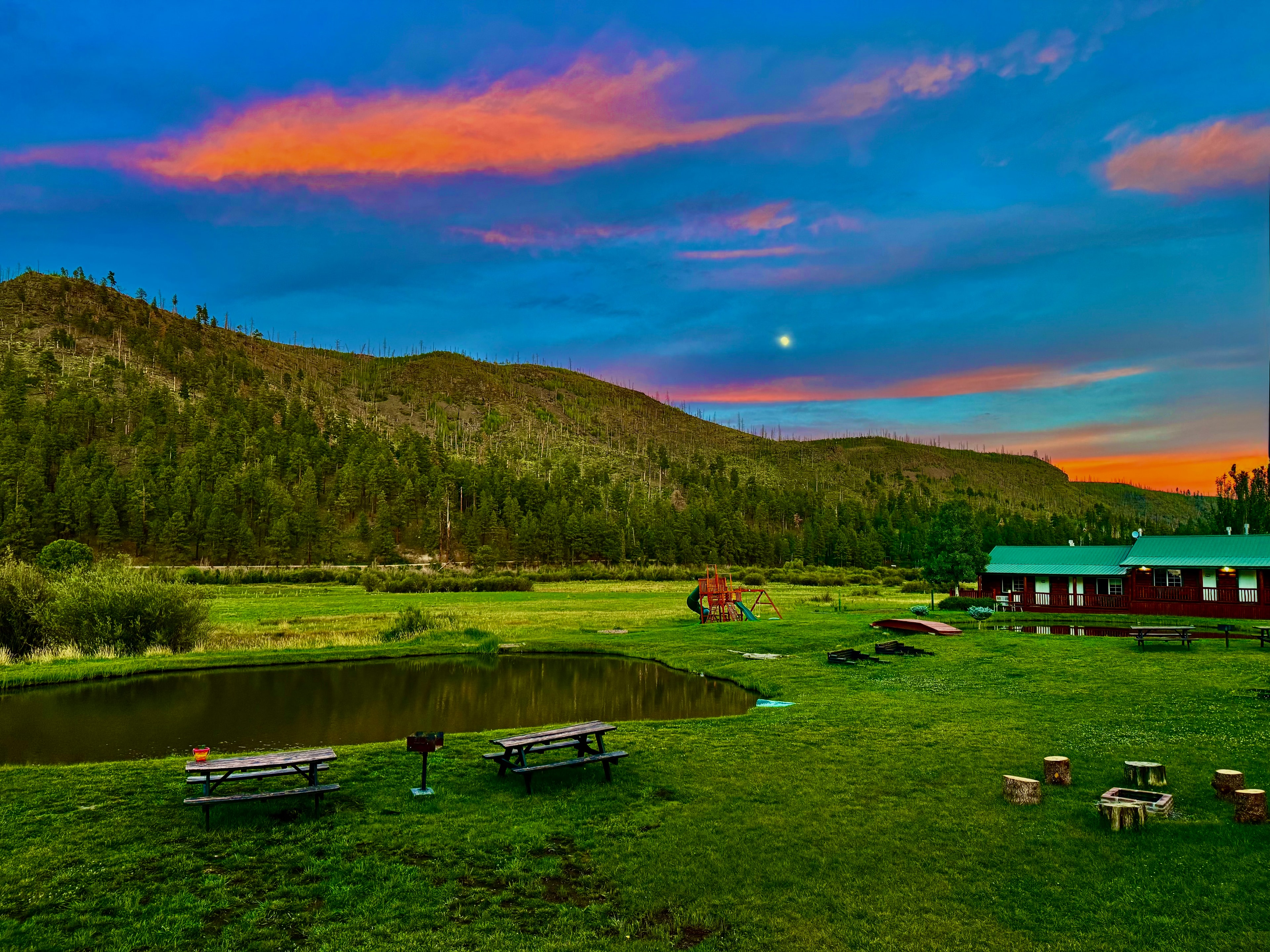 Alpenglow sunset over the pond and mountains at Greer Arizona